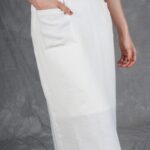 CHARLIZE midi skirt sewing pattern with pockets: close-up of the white skirt’s front patch pocket and straight cut.
