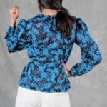 AGATHE blouse sewing pattern: back view of the blue patterned long-sleeved blouse, showing the softly fitted shirred waist.