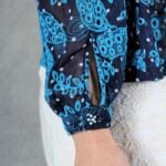 AGATHE blouse sewing pattern: close-up of the long-sleeve cuff with a narrow slit on the blue patterned blouse.