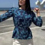 AGATHE blouse sewing pattern: navy-and-blue printed long-sleeved blouse with a gathered waist, worn outdoors.