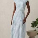 BELLA dress sewing pattern: three-quarter view of the striped midi dress highlighting curved seams and the gently flared skirt.