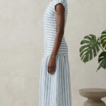 BELLA dress sewing pattern: side view of a striped summer dress with short cap sleeves and a softly shaped midi skirt.