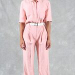 EMMA summer jumpsuit sewing pattern: pastel pink linen jumpsuit with turned-up short sleeves and relaxed wide-leg trousers.