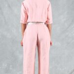 Back view of the EMMA jumpsuit sewing pattern in pink linen, showing the shaped waist and straight trouser legs.