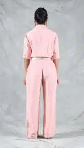 Rear view of a me-made women’s jumpsuit in soft pink, showing back waistband and straight-leg trousers – part of a beginner-friendly one-piece sewing pattern with modern fit.