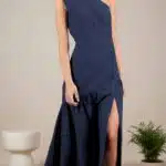 ASYM maxi evening dress sewing pattern, navy-blue one-shoulder gown with a draped waist and a long skirt opening into a dramatic side slit.