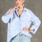 GALATEE women’s shirt sewing pattern: front view of the loose pale-blue floral shirt, showing its open collar and asymmetric curved hem.