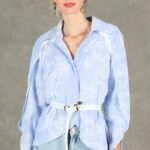 GALATEE belted shirt sewing pattern: pale-blue floral collared shirt with white belt, loose sleeves and overlapping curved front hem.