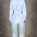 GALATEE shirt sewing pattern with back box pleat: rear view of the pale-blue floral shirt shaped with a white waist belt.