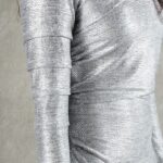 HYPE dress sewing pattern: close-up of the silver fabric, waist gathers and long sleeve.