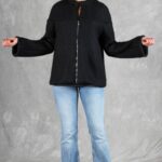 LYNN relaxed-fit jacket sewing pattern: full view of the black slightly flared jacket with arms extended to show its width.