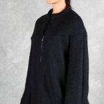 LYNN dropped-shoulder jacket sewing pattern: side view of the loose black jacket showing its relaxed sleeve and silhouette.