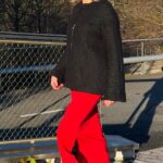 LYNN relaxed jacket sewing pattern: black slightly flared jacket worn outdoors with a long red skirt and black boots.