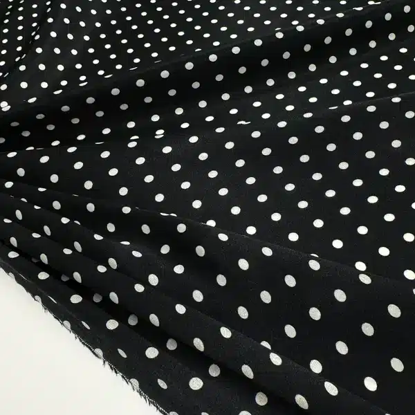 Tejido de algodón negro con lunares blancos - colección de lunares verano 2026 Torretto Tessuti