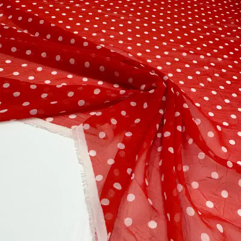 Voile rojo vibrante con lunares blancos - tejido ligero y translúcido de verano de Torretto Tessuti