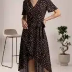 SIENNA wrap dress sewing pattern: full-length view of a brown polka-dot dress with a tied waist and asymmetric hem.