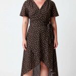 SIENNA summer wrap dress sewing pattern: front view of a brown polka-dot dress with crossover bodice and shorter front hem.