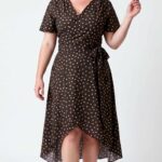 SIENNA asymmetric wrap dress sewing pattern: front view of the polka-dot dress with short flared sleeves and wrap skirt opening.