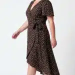 SIENNA wrap dress PDF sewing pattern: profile view of the dotted dress with tied waist and a skirt longer at the back.