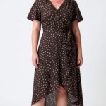 SIENNA women’s wrap dress sewing pattern: full front view of the brown polka-dot dress with short sleeves and waist tie.