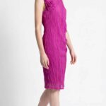 Side view of the NAIA dress sewing pattern in fuchsia, highlighting the fitted silhouette and fluid draped fabric.