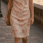 NAIA pleated dress sewing pattern, front view of a knee-length dress made in a soft pink floral print.