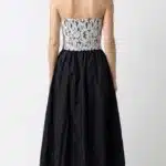 Back view of the ECLIPSE strapless bustier sewing pattern, showing the fitted floral lace back above a black full skirt.