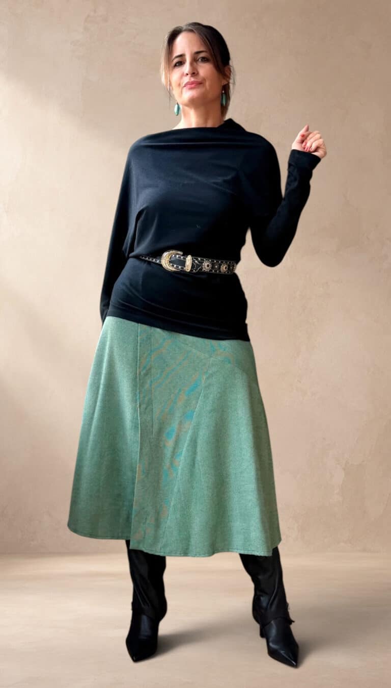 Model wearing a skirt made from the CHANTELLE sewing pattern: the patchwork lines continue into a softly spreading midi hem. Suitable for a distinctive handmade everyday outfit.